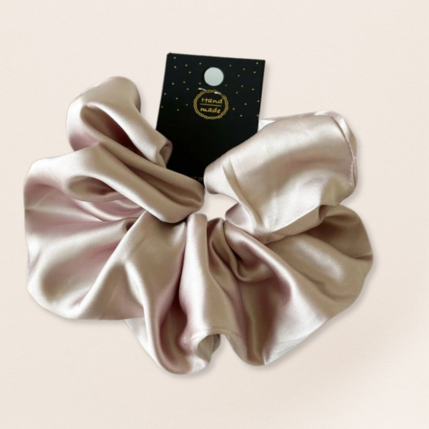 Beige satin scrunchie for fine hair on a beige background