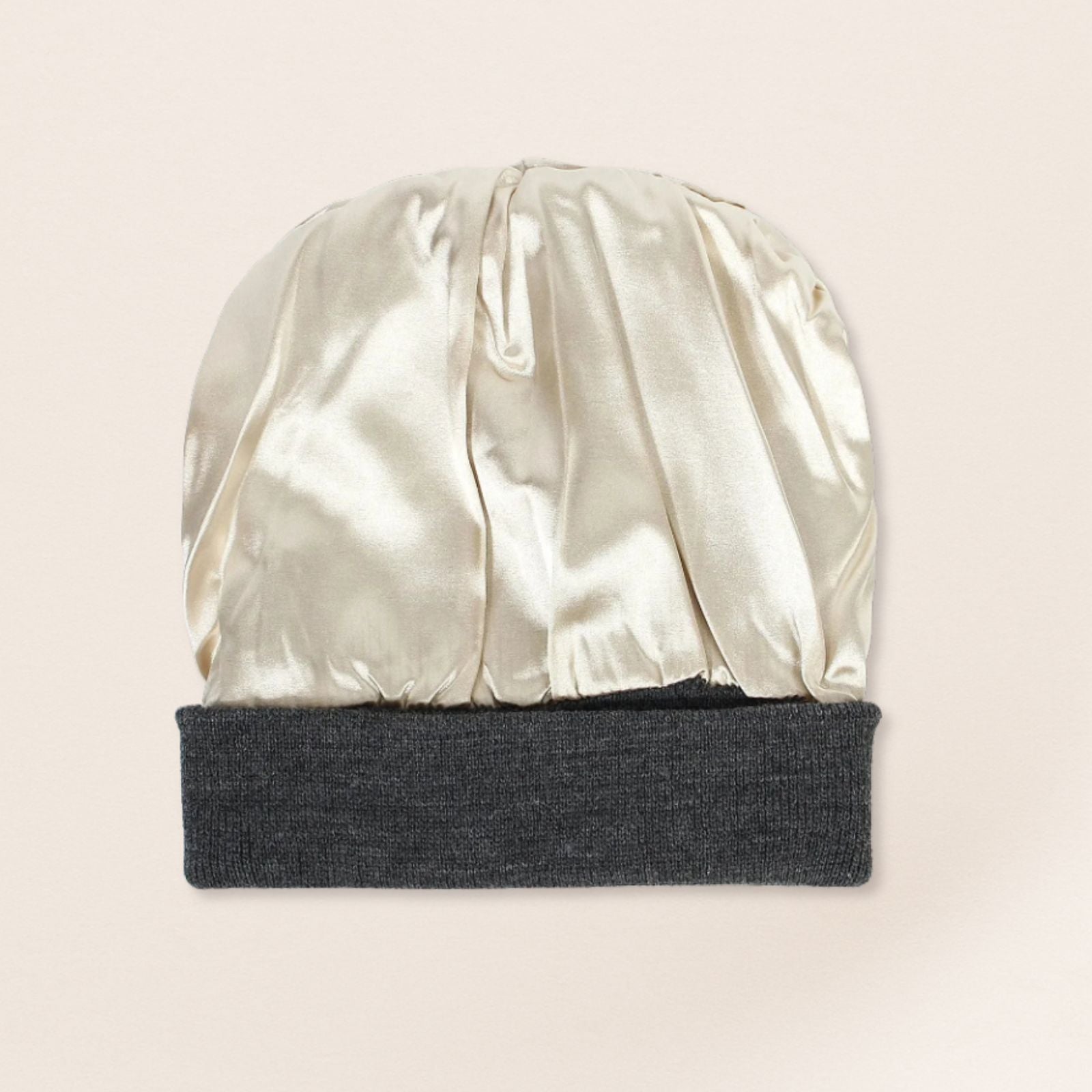 Two-toned beanie with satin interior and knit top on a beige background