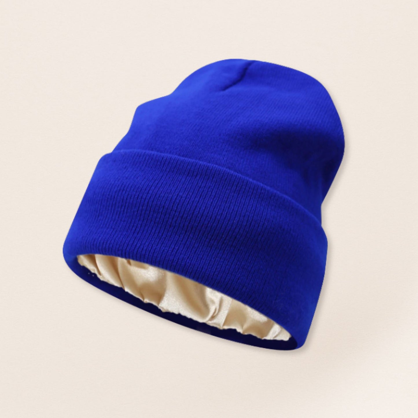 blue beanie with satin interior on a beige background