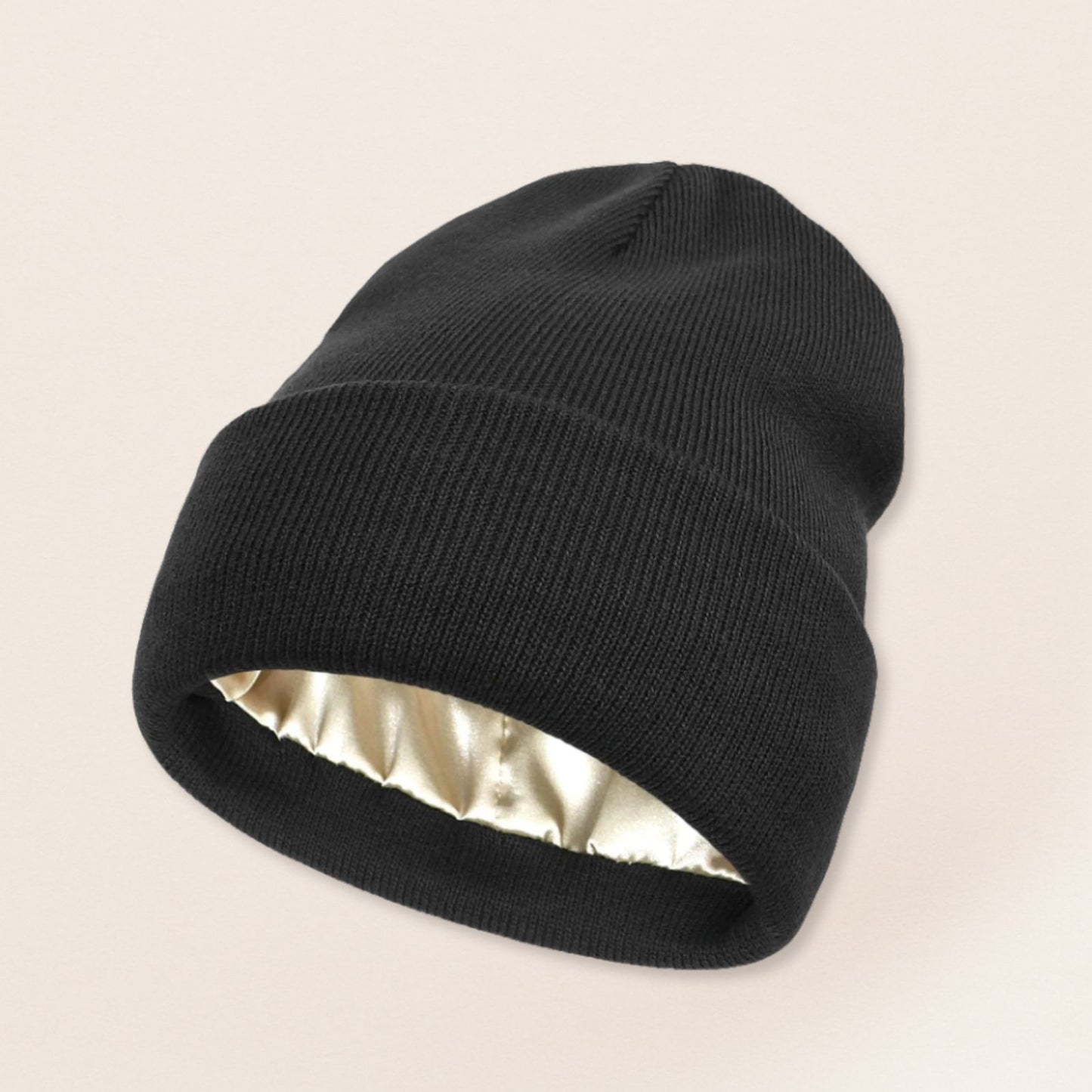 Black beanie with satin interior on a beige background