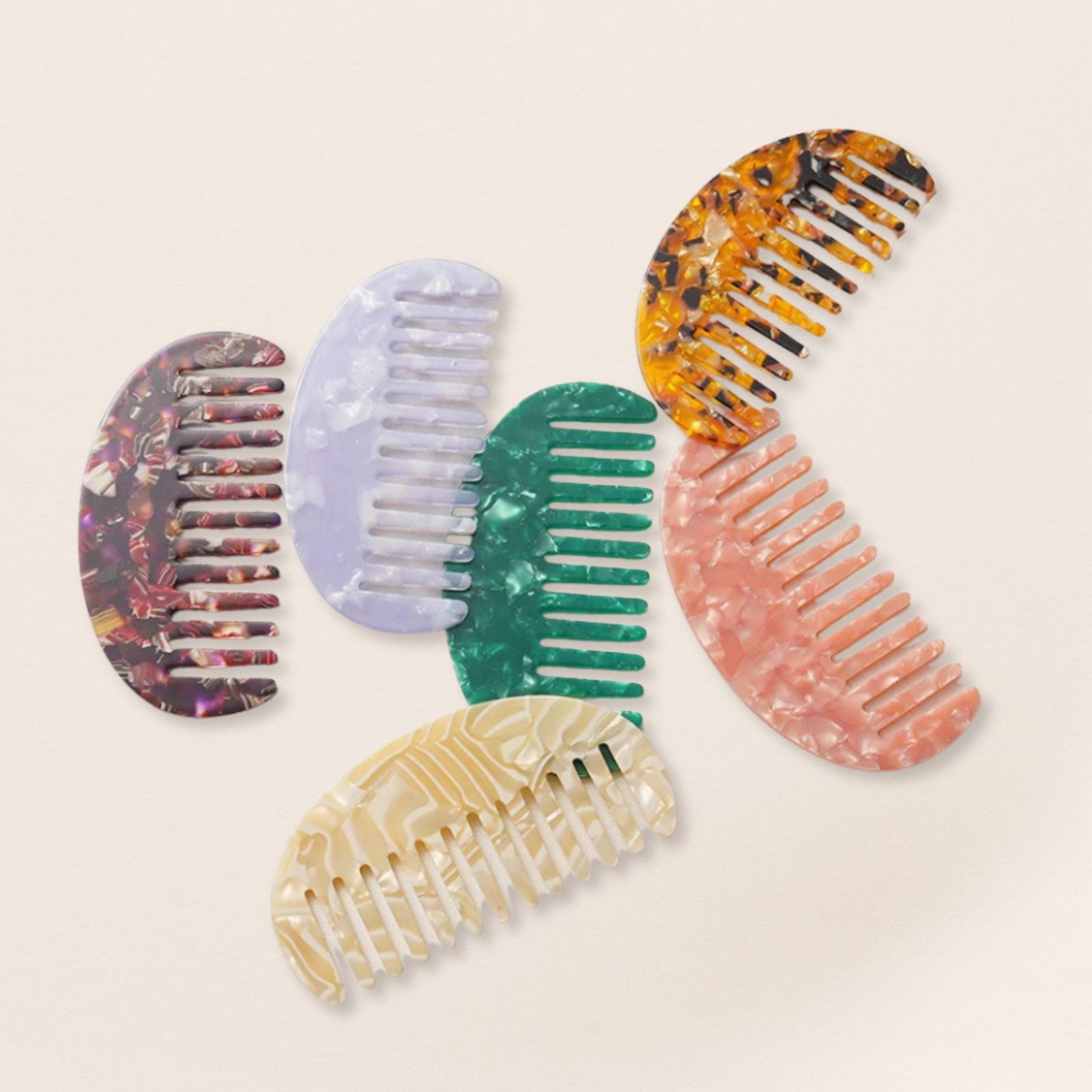 Lightweight marbled half-moon combs for fine hair on a beige background.