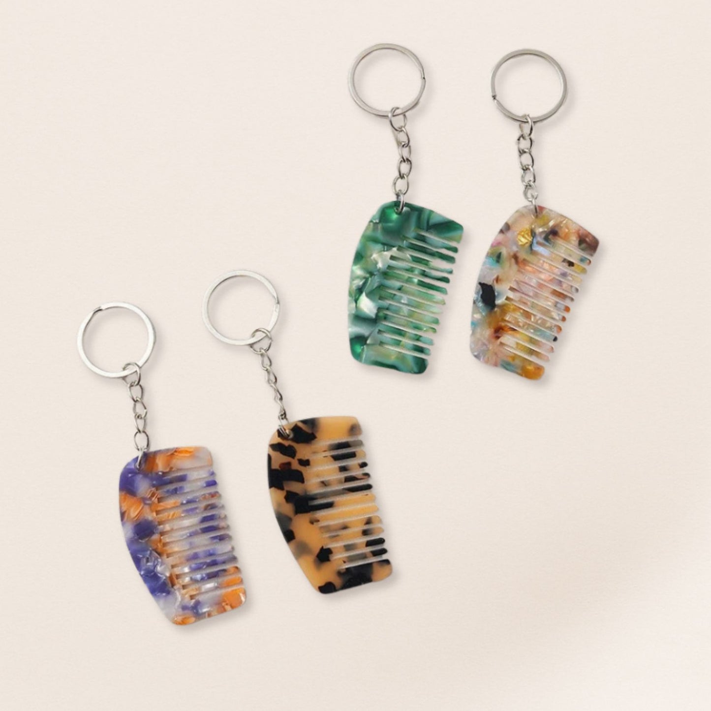 Four multicolored keychains shaped like flip-flops on a beige background