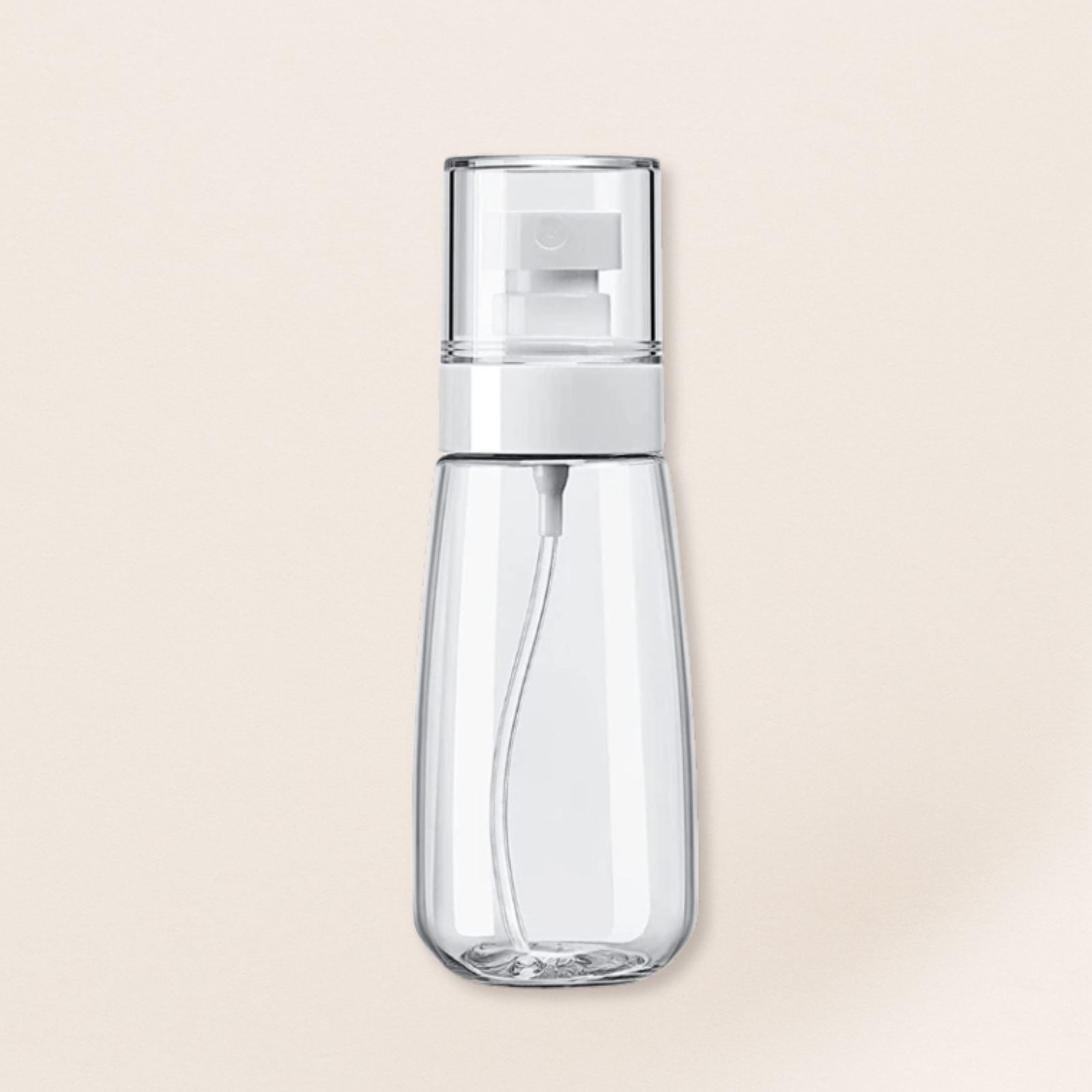 Clear spray bottle with white nozzle on a beige background