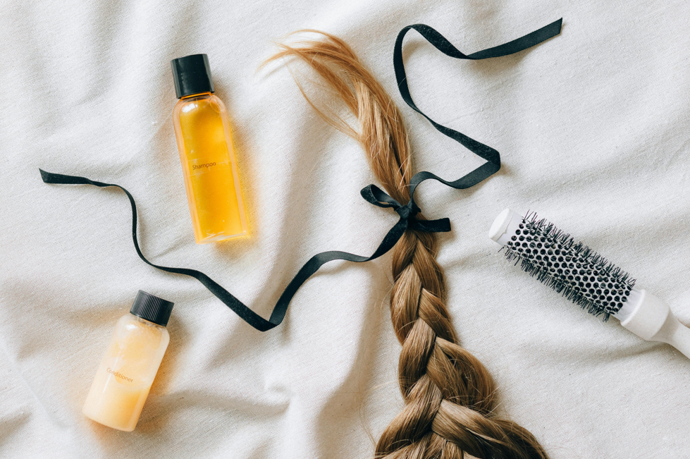 Light brown hair in a plait and hair care products