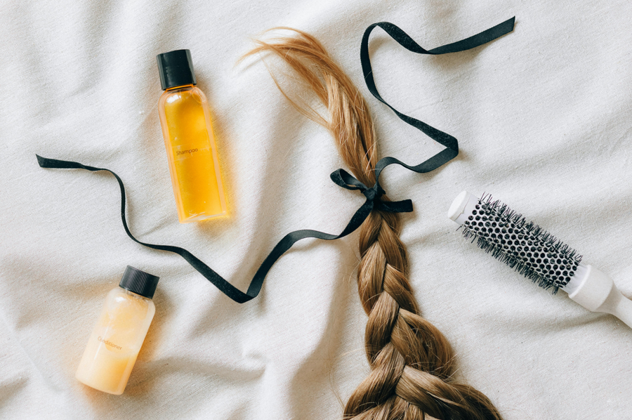 Light brown hair in a plait and hair care products