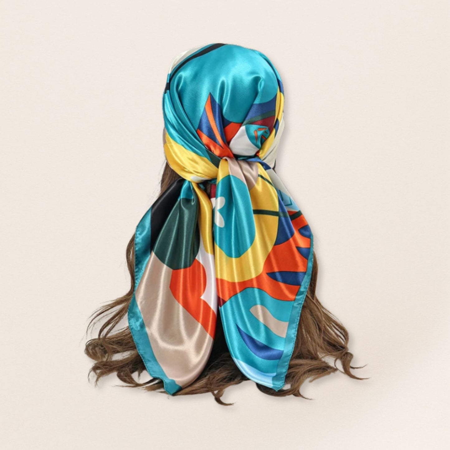 Colourful patterned headscarf on a person with a beige background