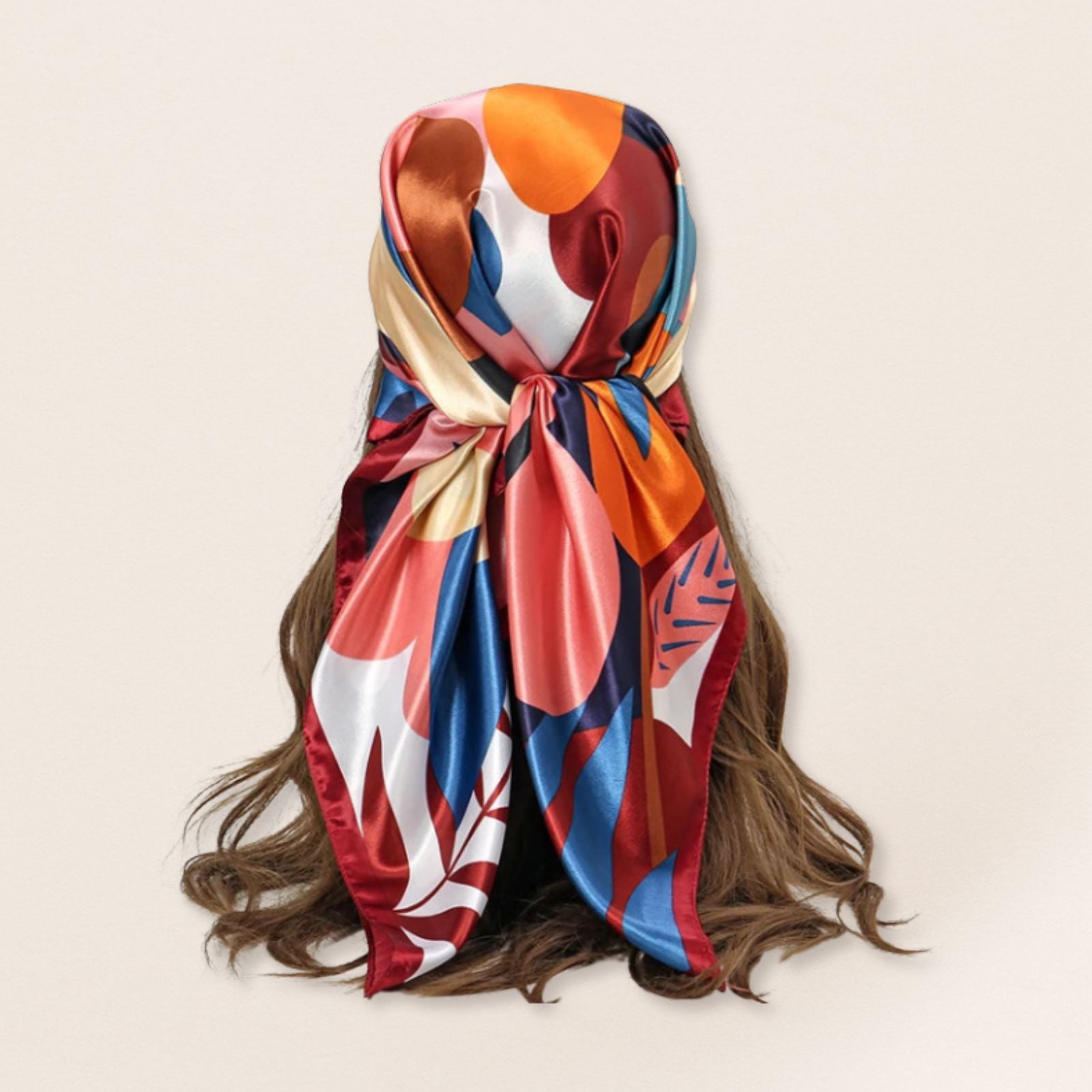 Colourful scarf tied around a person's head with a beige background