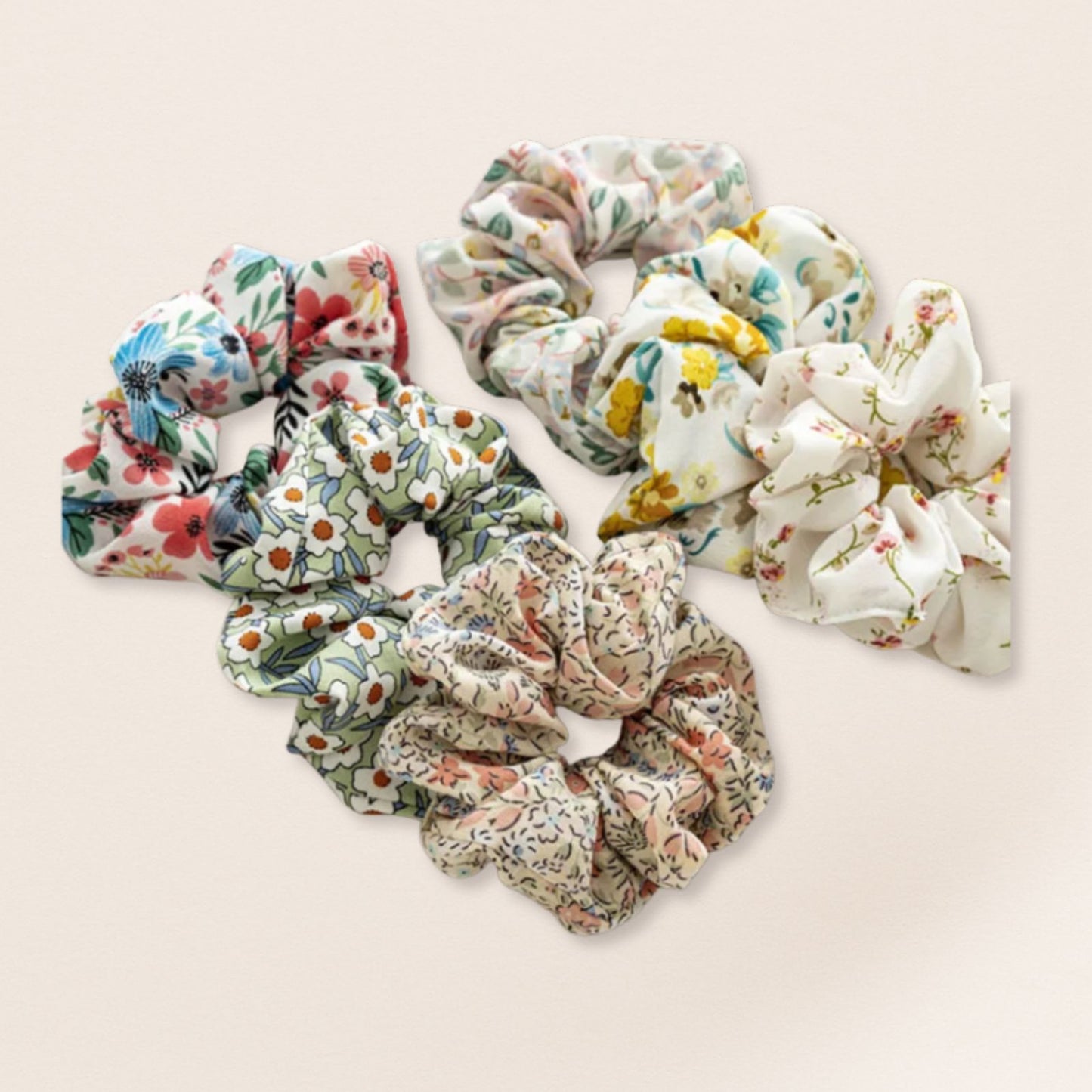 Set of floral scrunchies for fine hair on a light beige background