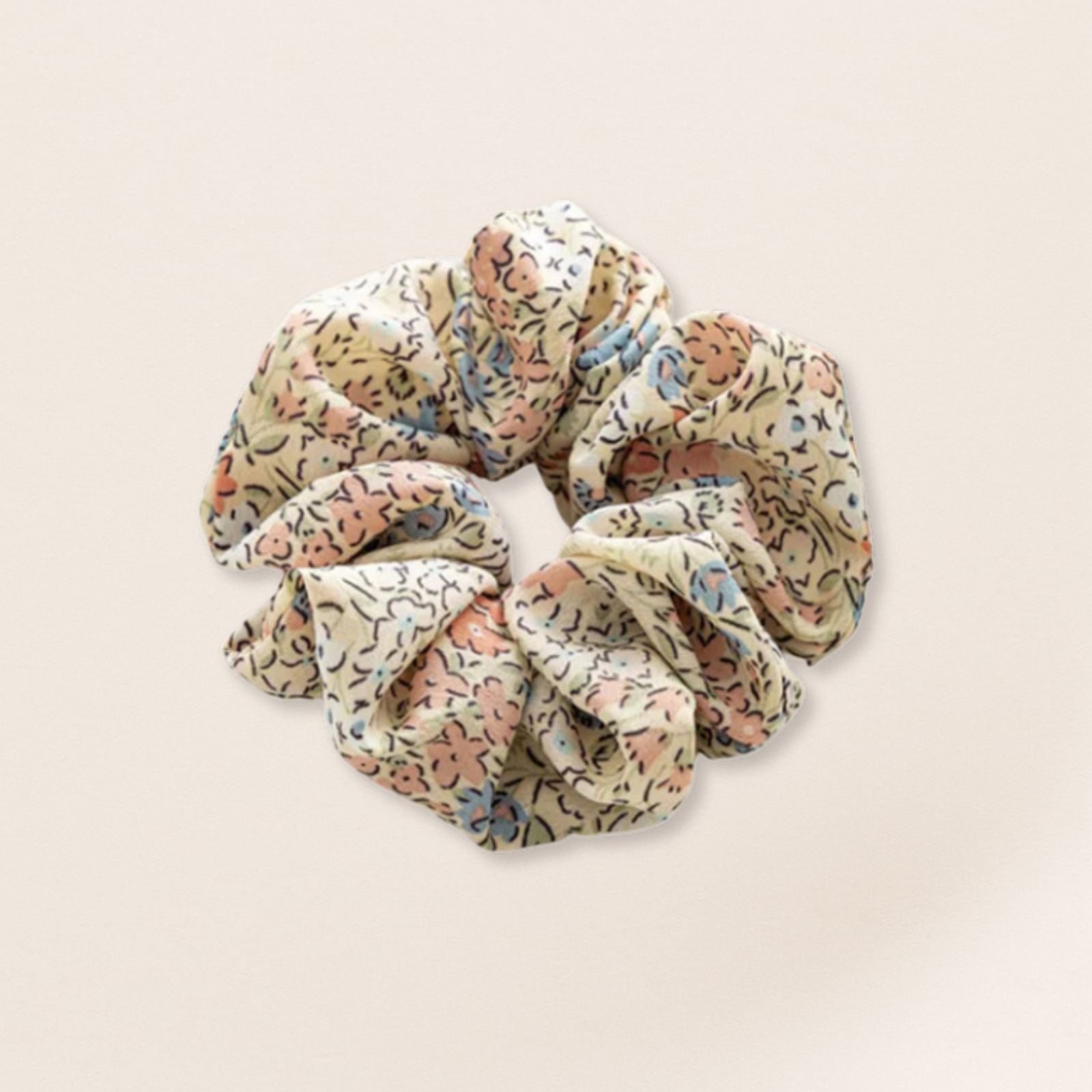 Floral patterned scrunchie for fine hair on a beige background