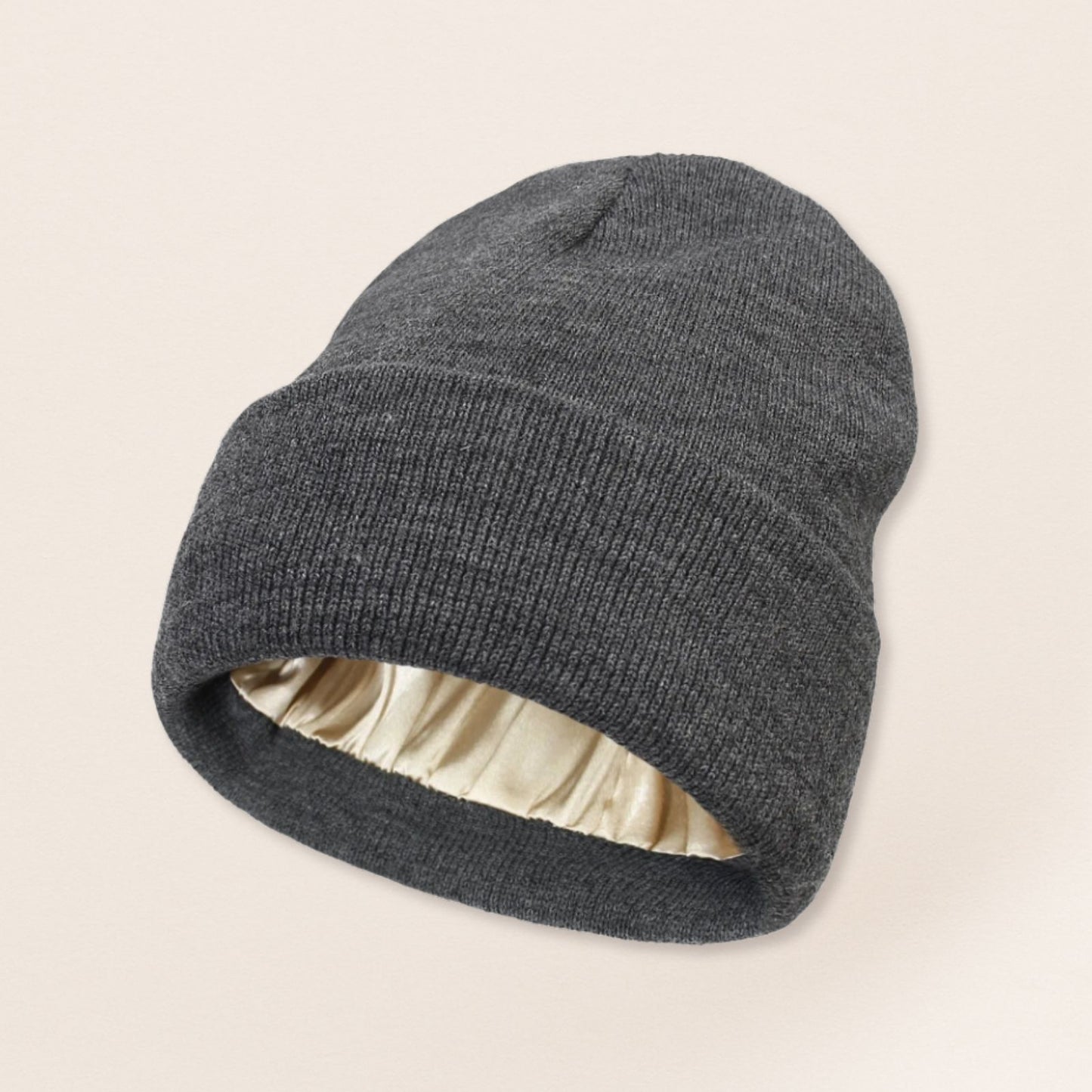 Gray beanie with satin interior on a beige background