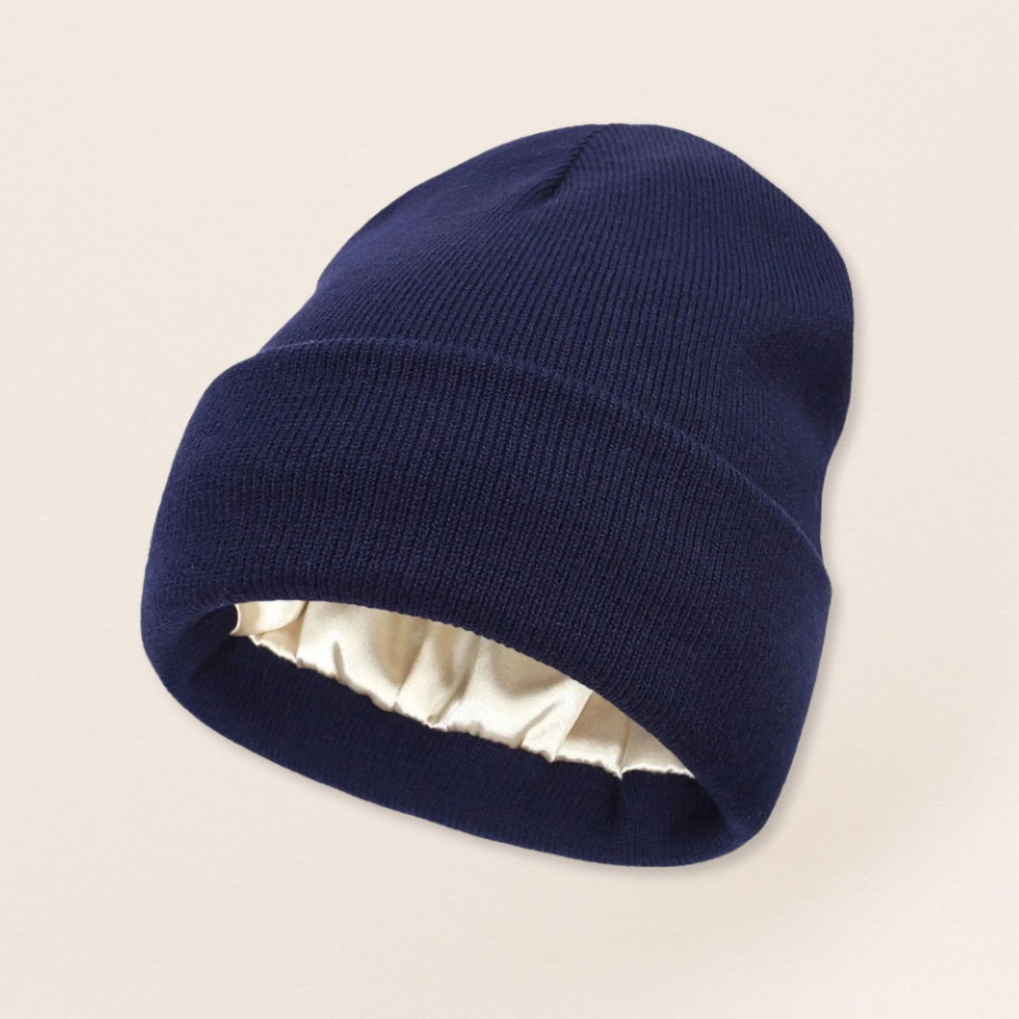 Navy blue beanie with satin interior on a beige background