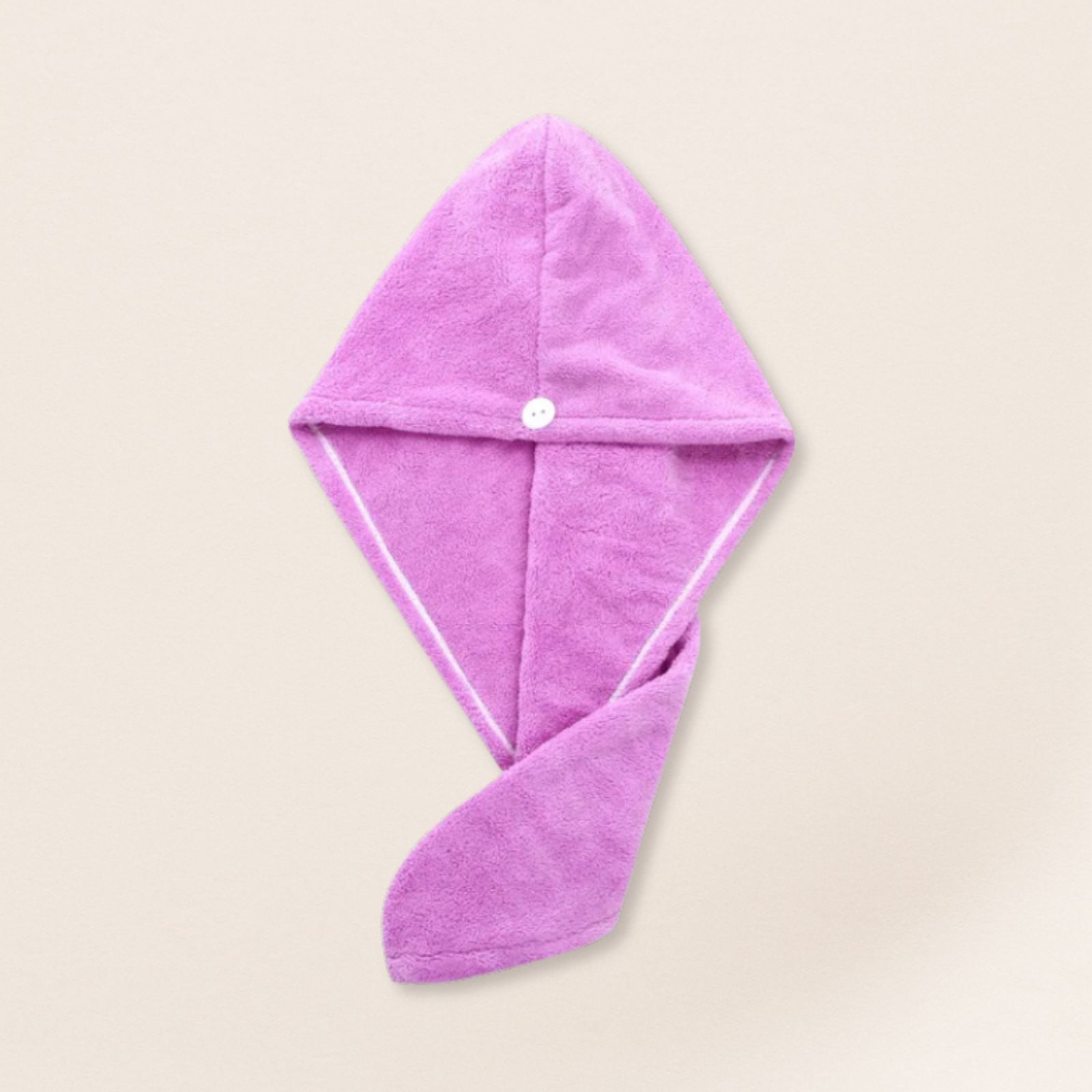 Purple microfiber towel for fine hair on a beige background