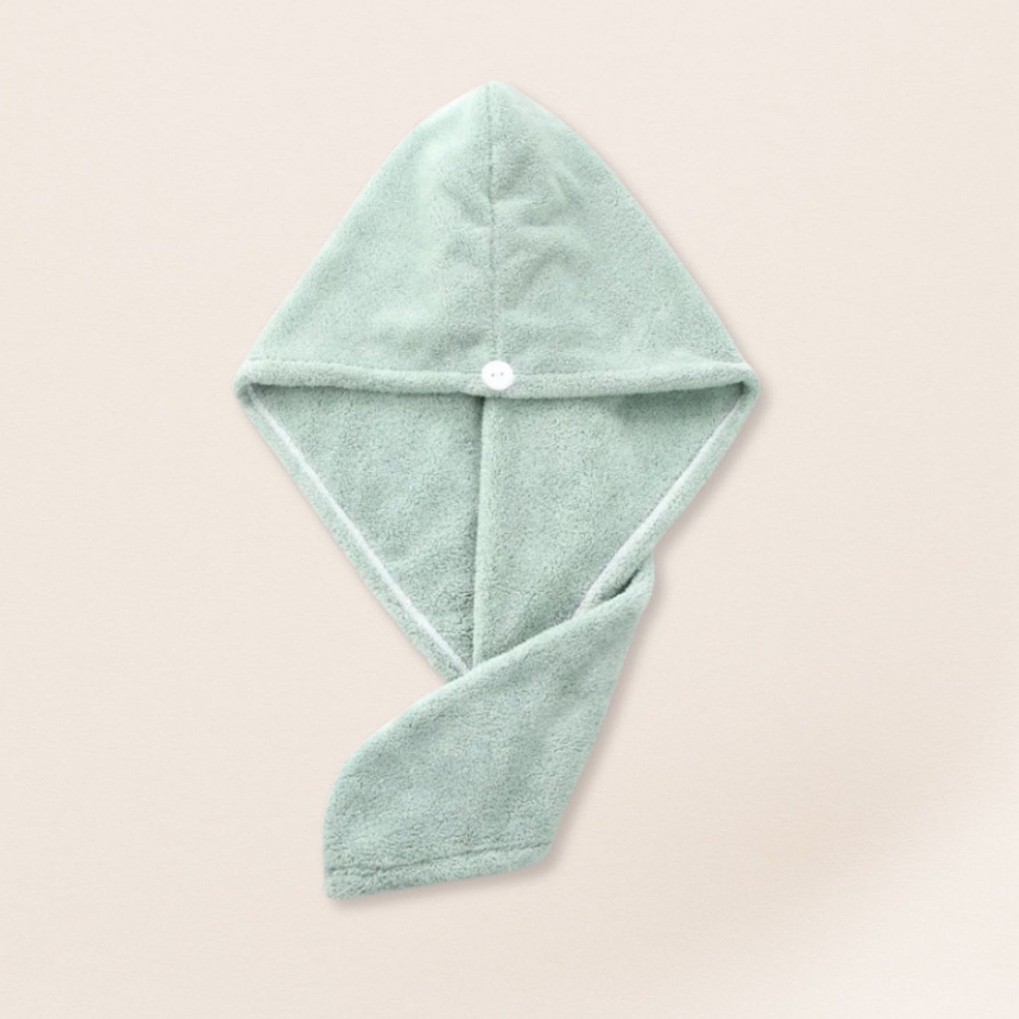 light green microfiber towel for fine hair on a beige background