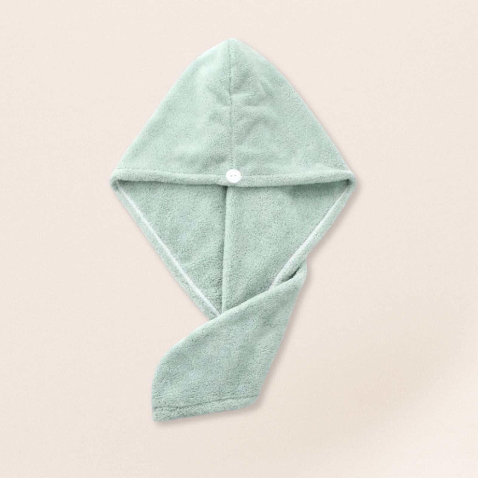 light green microfiber towel for fine hair on a beige background