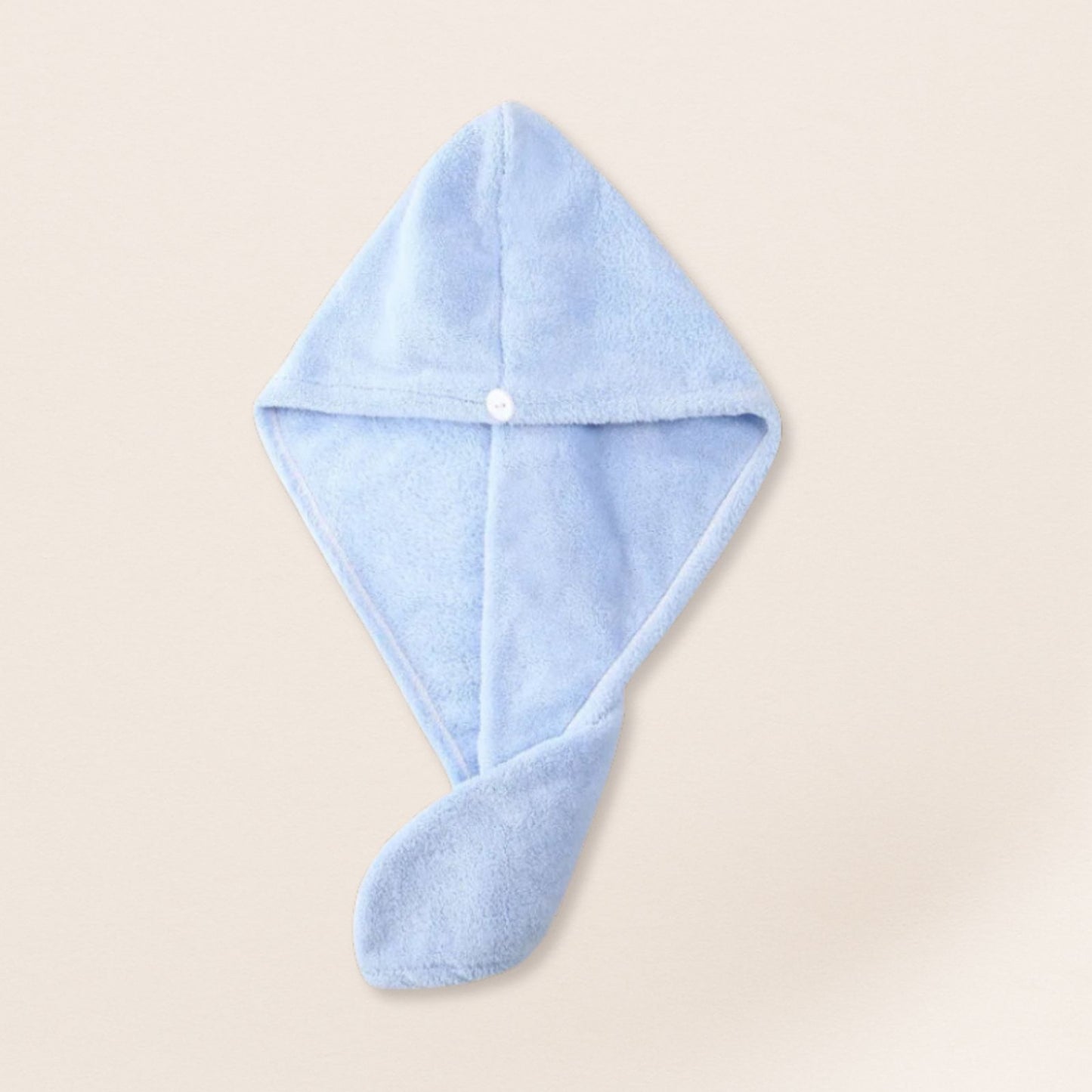 Blue microfiber towel for fine hair on a beige background