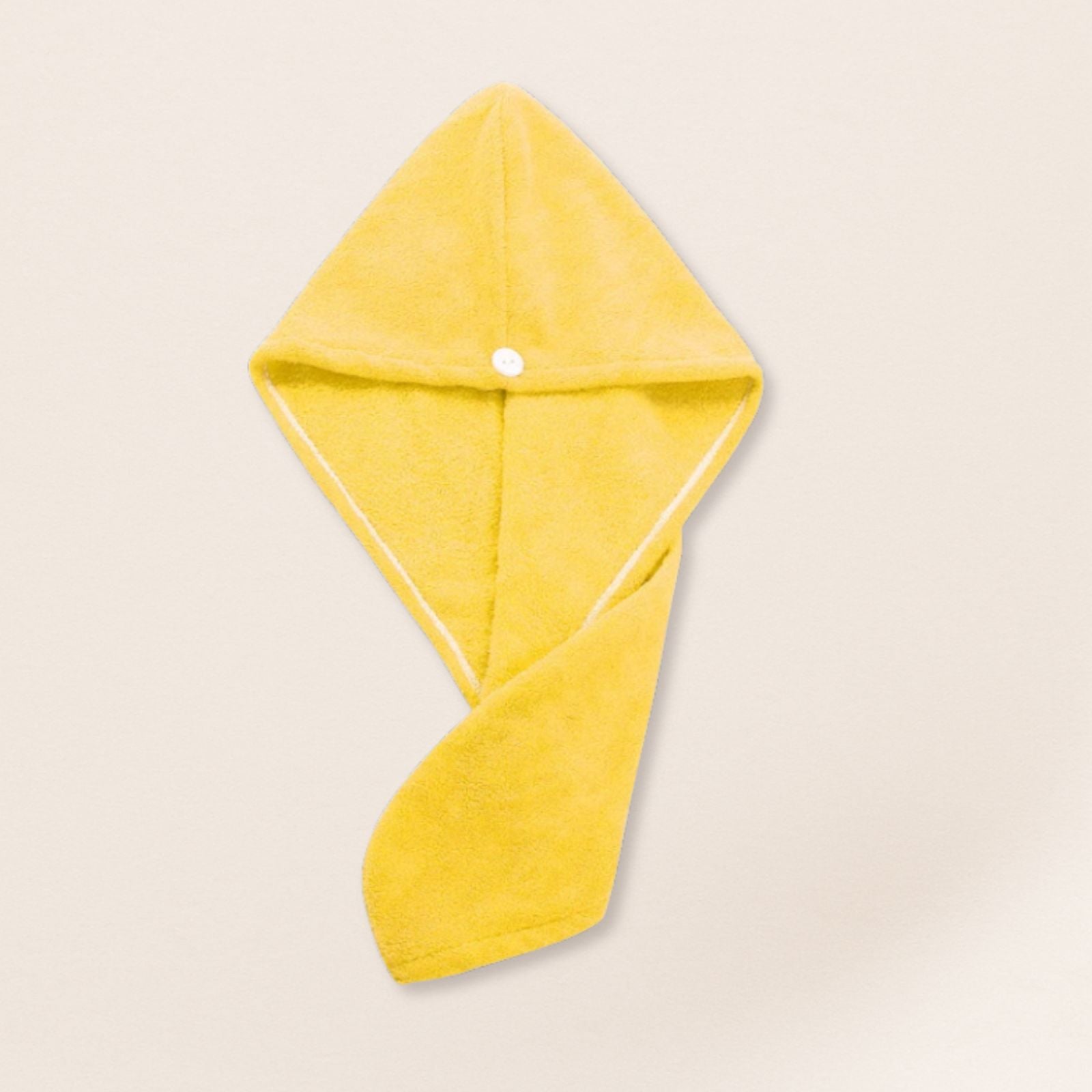 Yellow microfiber towel for fine hair on a beige background