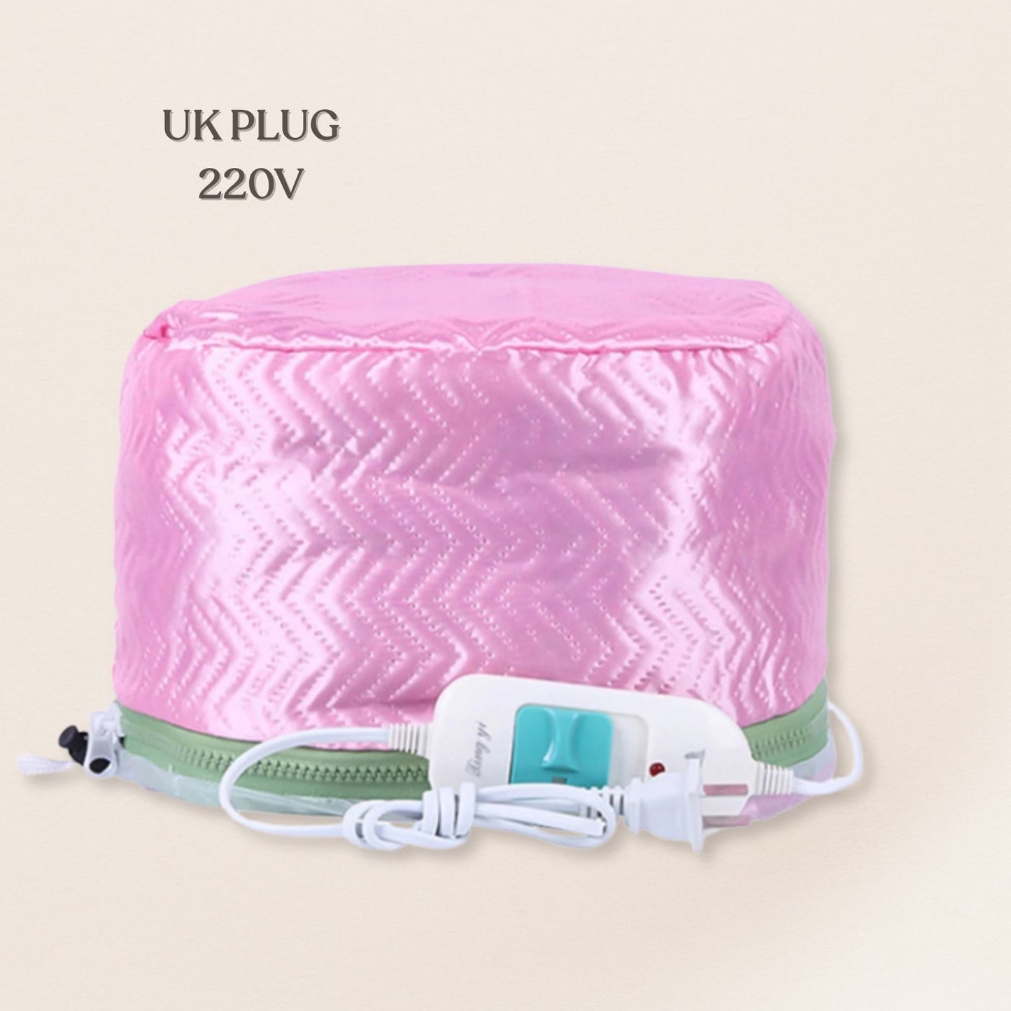 Pink heating pad with a UK plug and 220V rating on a beige background