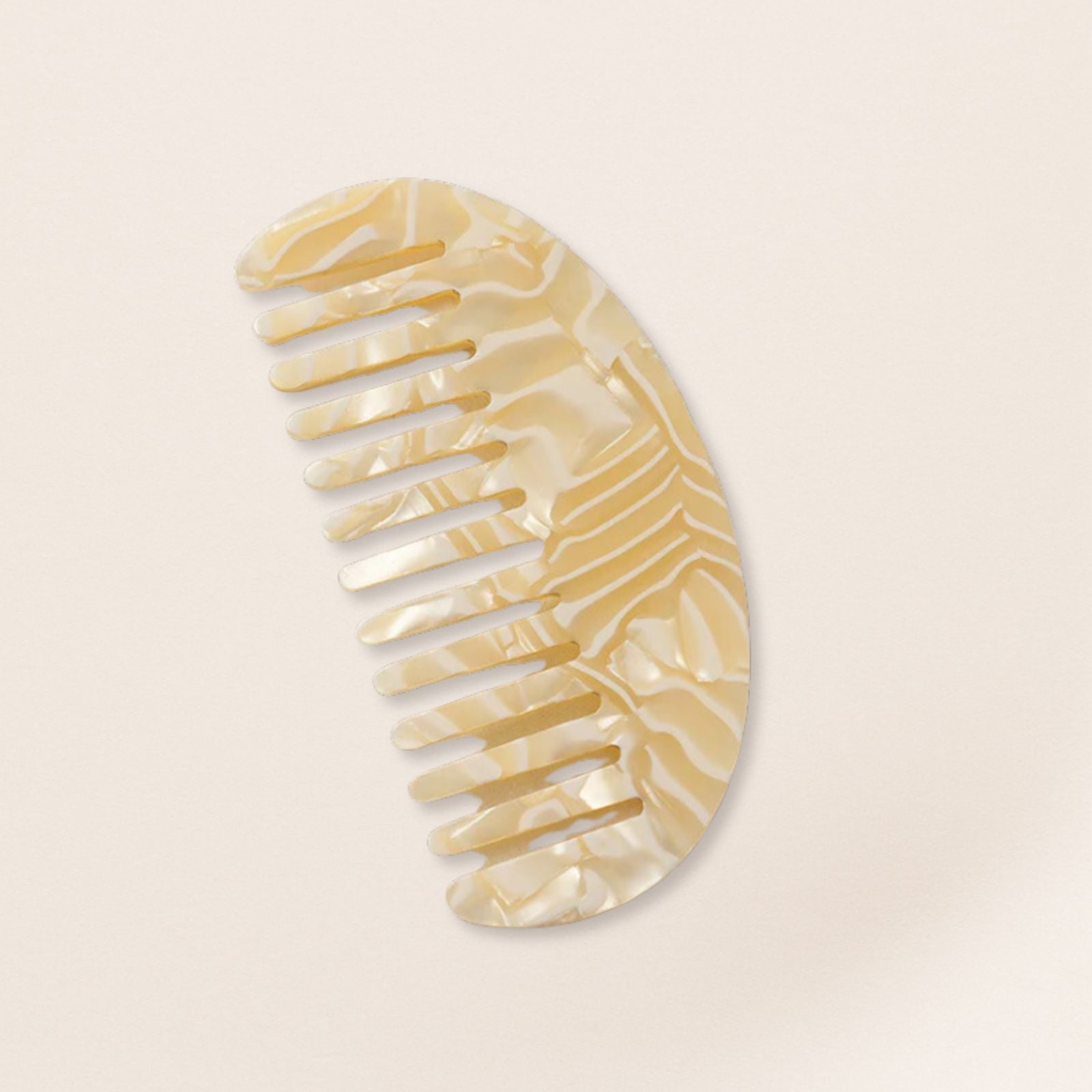 Lightweight cream marbled half-moon comb for fine hair on a beige background.