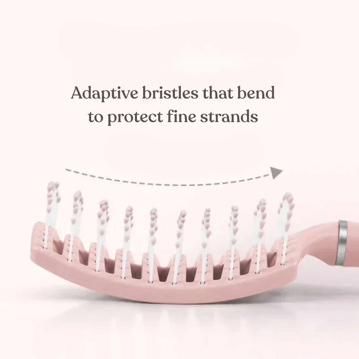 Pink hairbrush with adaptive bristles on a white background