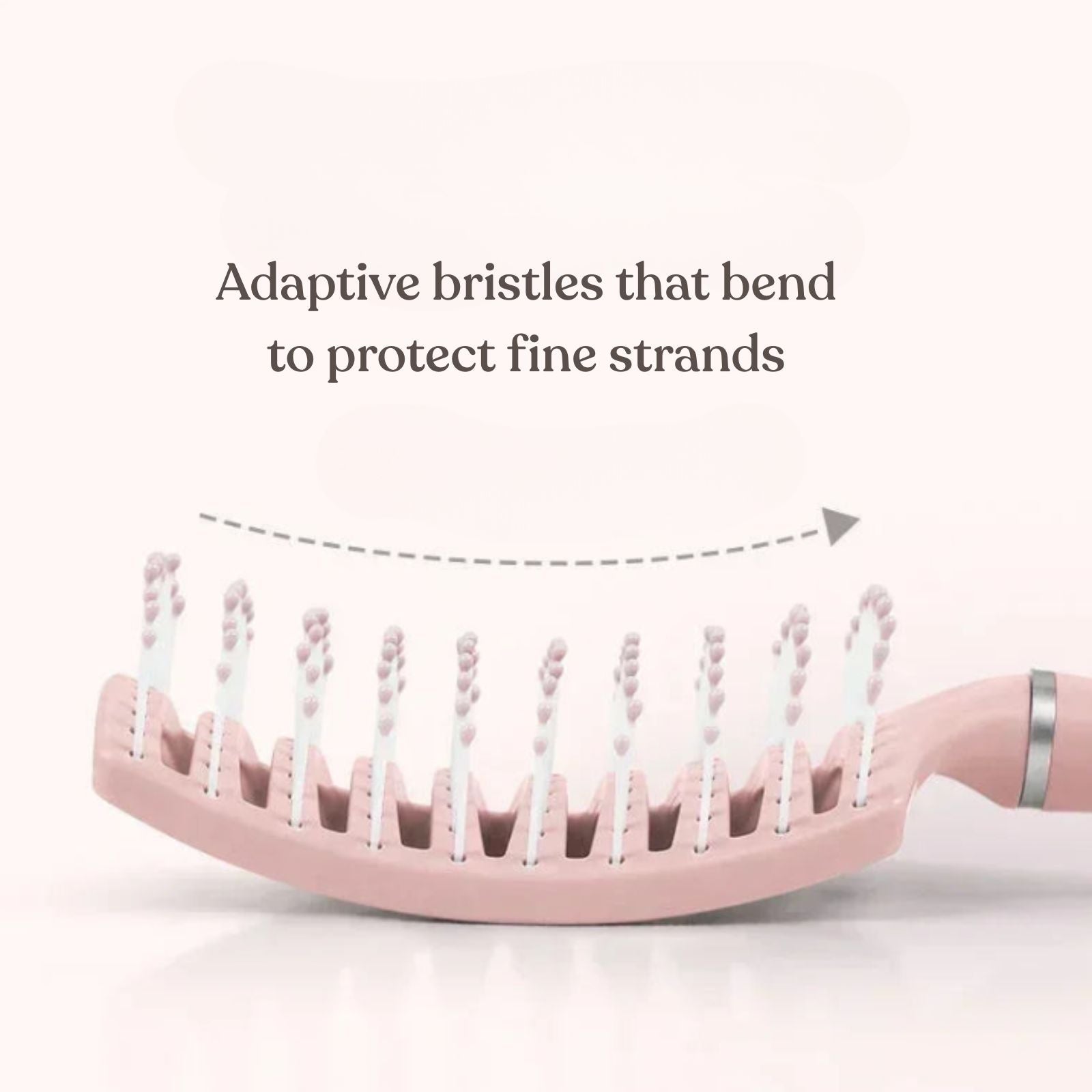 Pink hairbrush with adaptive bristles on a white background