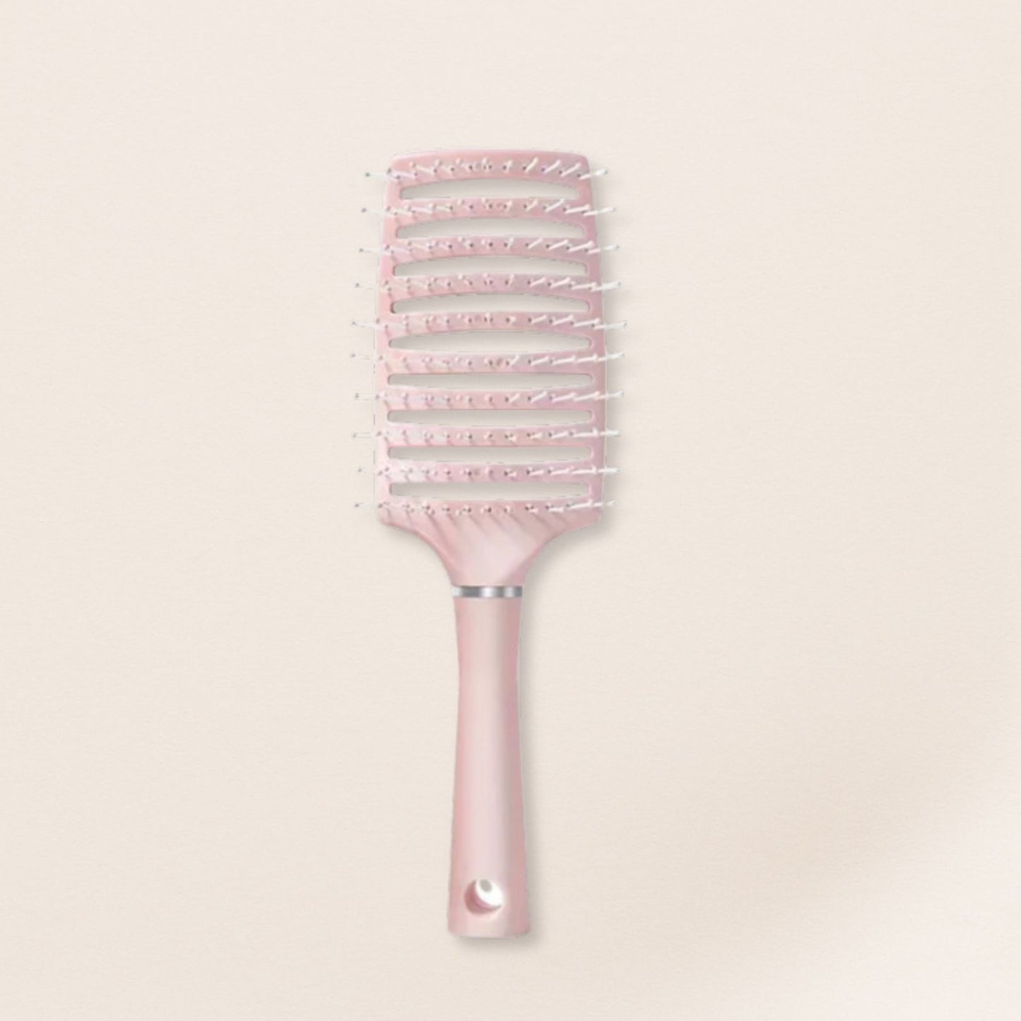 Pink hairbrush for fine hair with decorative bristles on a light beige background