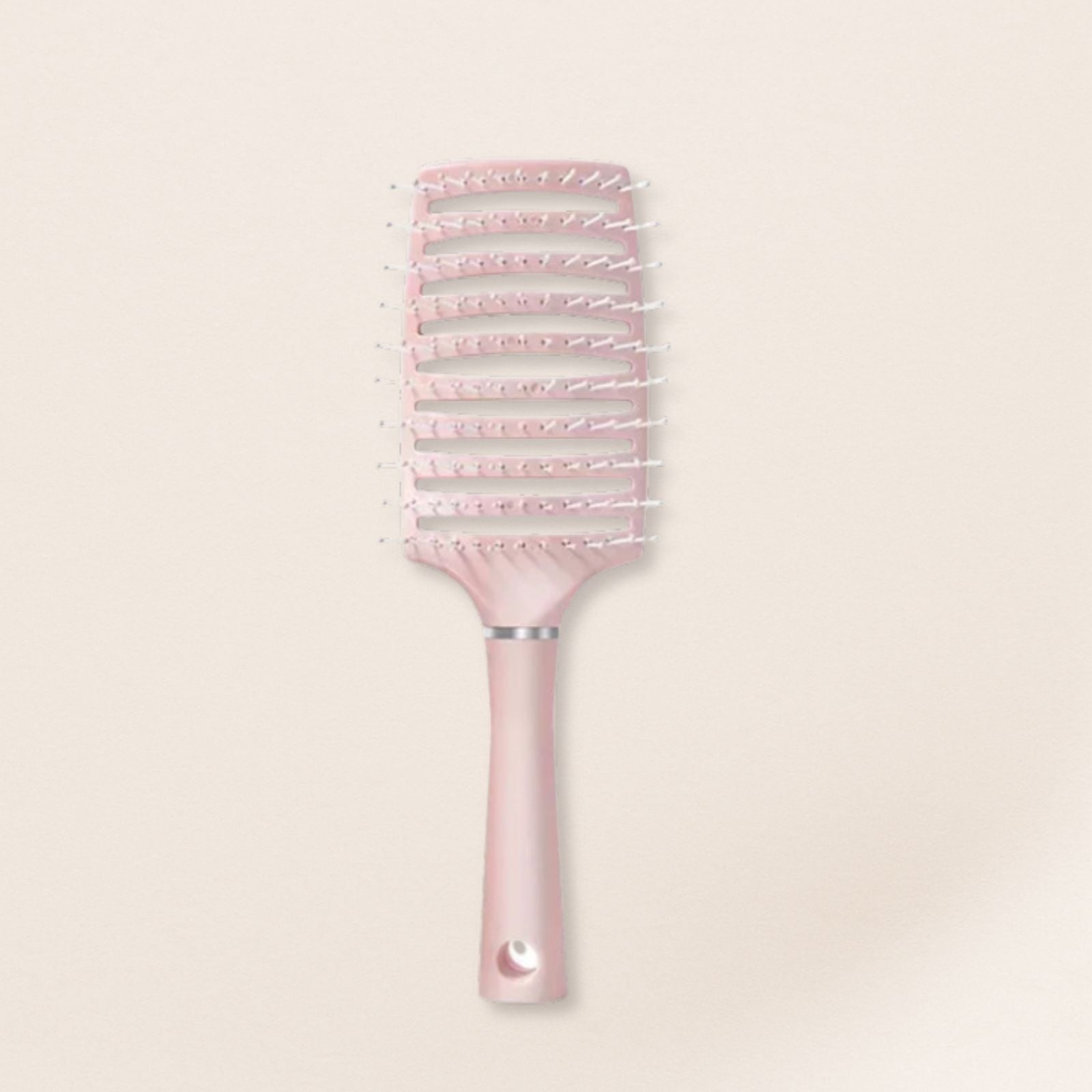 Pink hairbrush for fine hair with decorative bristles on a light beige background