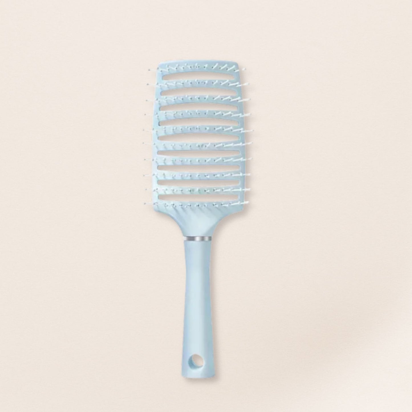 Light blue hairbrush for fine hair on a beige background
