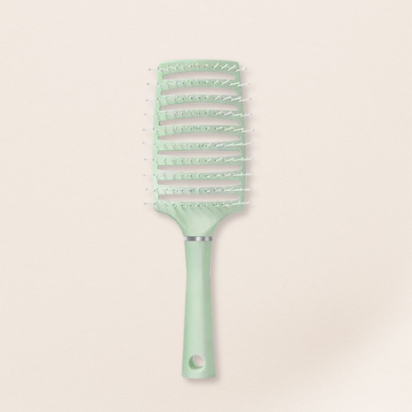 Mint green hairbrush for fine hair on a beige background