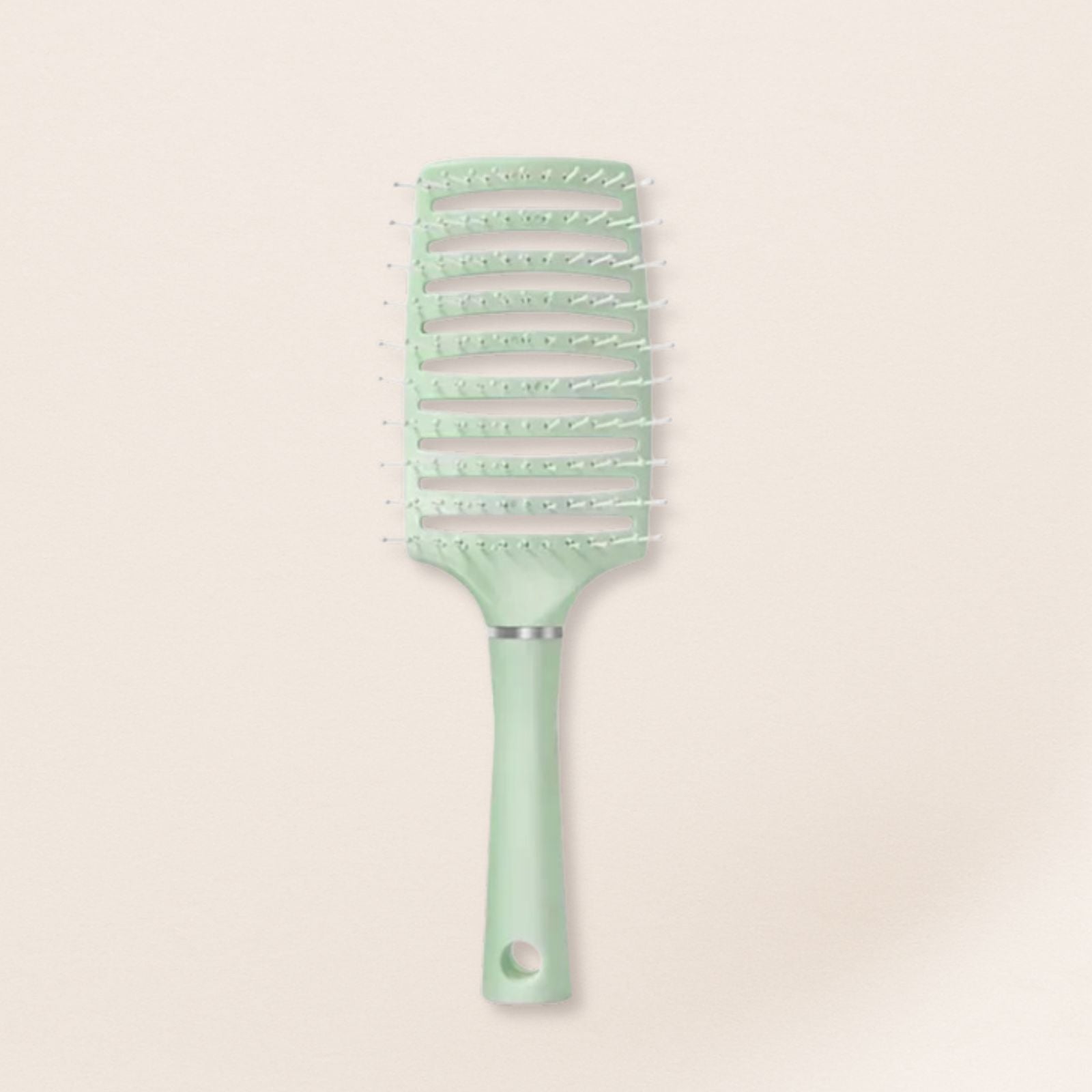 Mint green hairbrush for fine hair on a beige background
