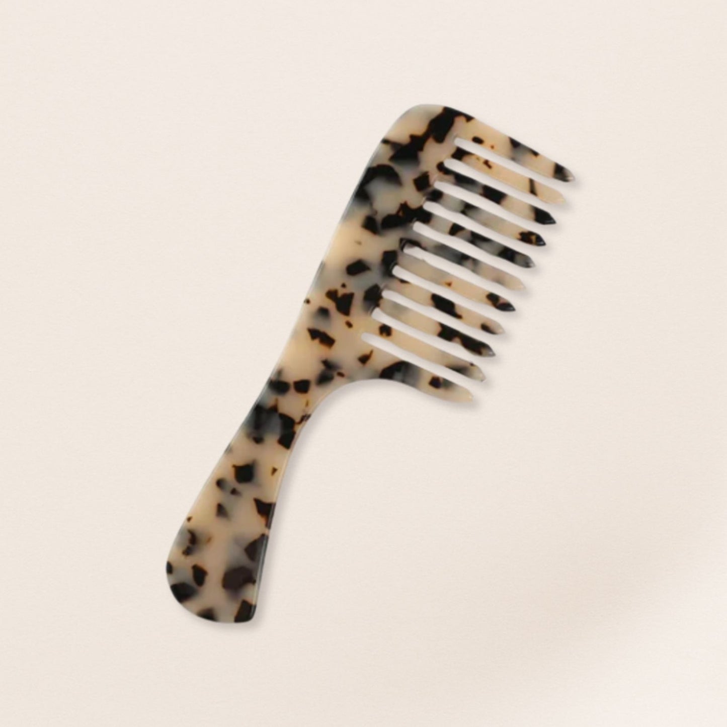 marbled wide-tooth combs for gentle detangling, displayed on a beige background.