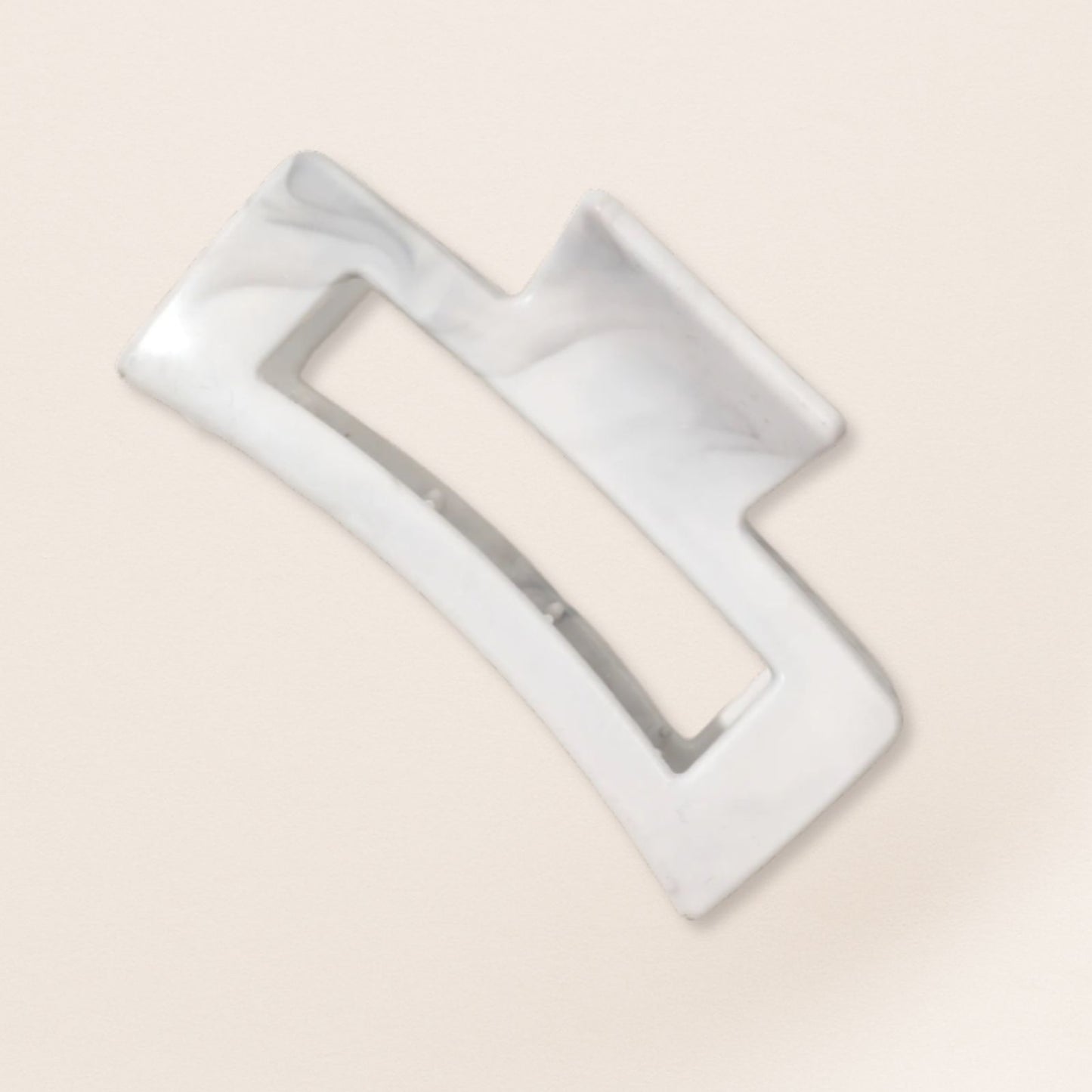 White claw clip for fine hair on a beige background