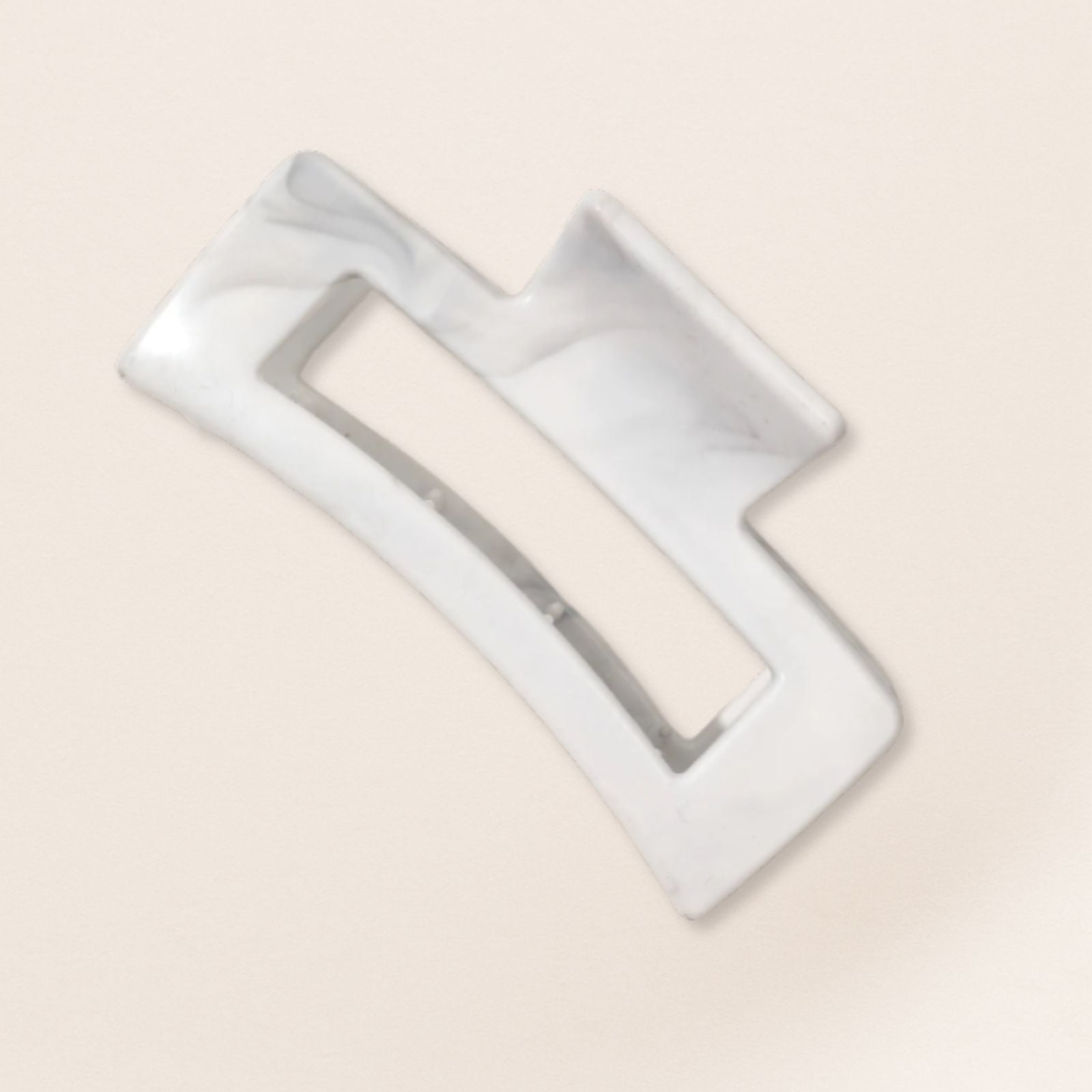 White claw clip for fine hair on a beige background