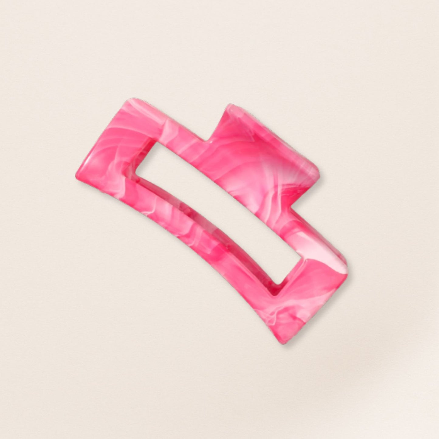 Pink marbled hair clip for fine hair on a beige background