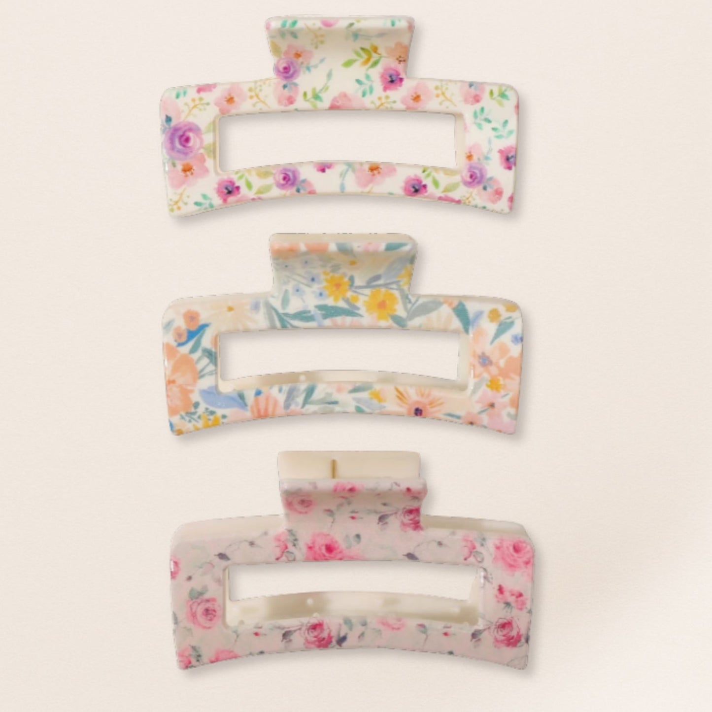 Set of floral-patterned hair clips on a light beige background
