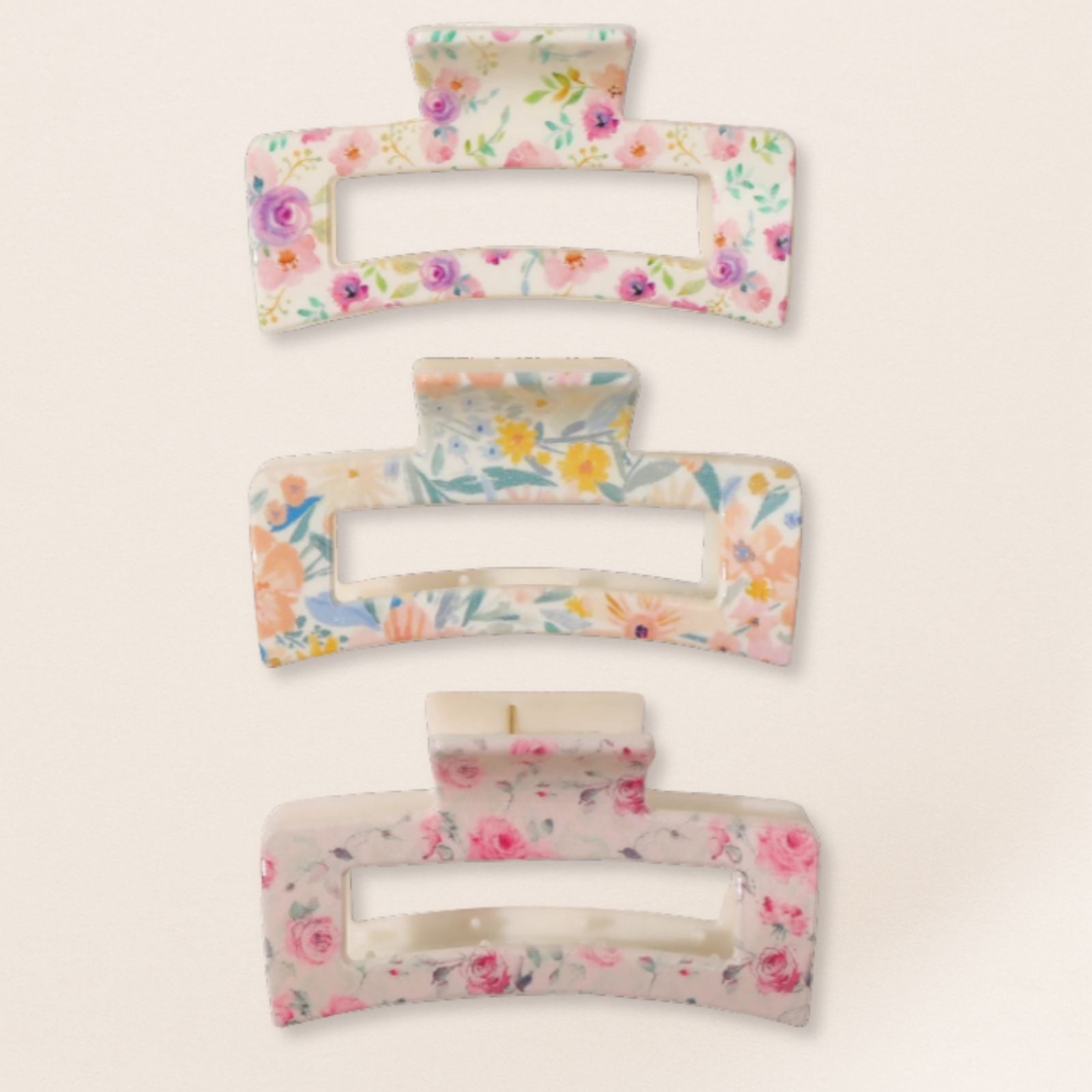 Set of floral-patterned hair clips on a light beige background