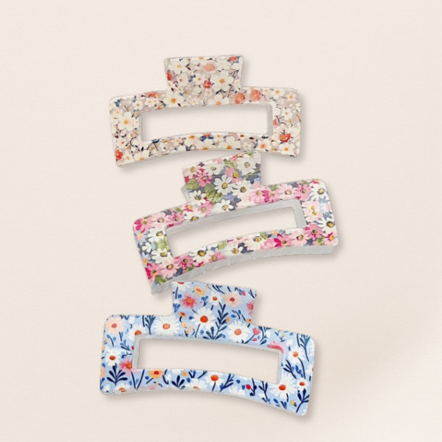 Set of floral-patterned hair clips on a beige background