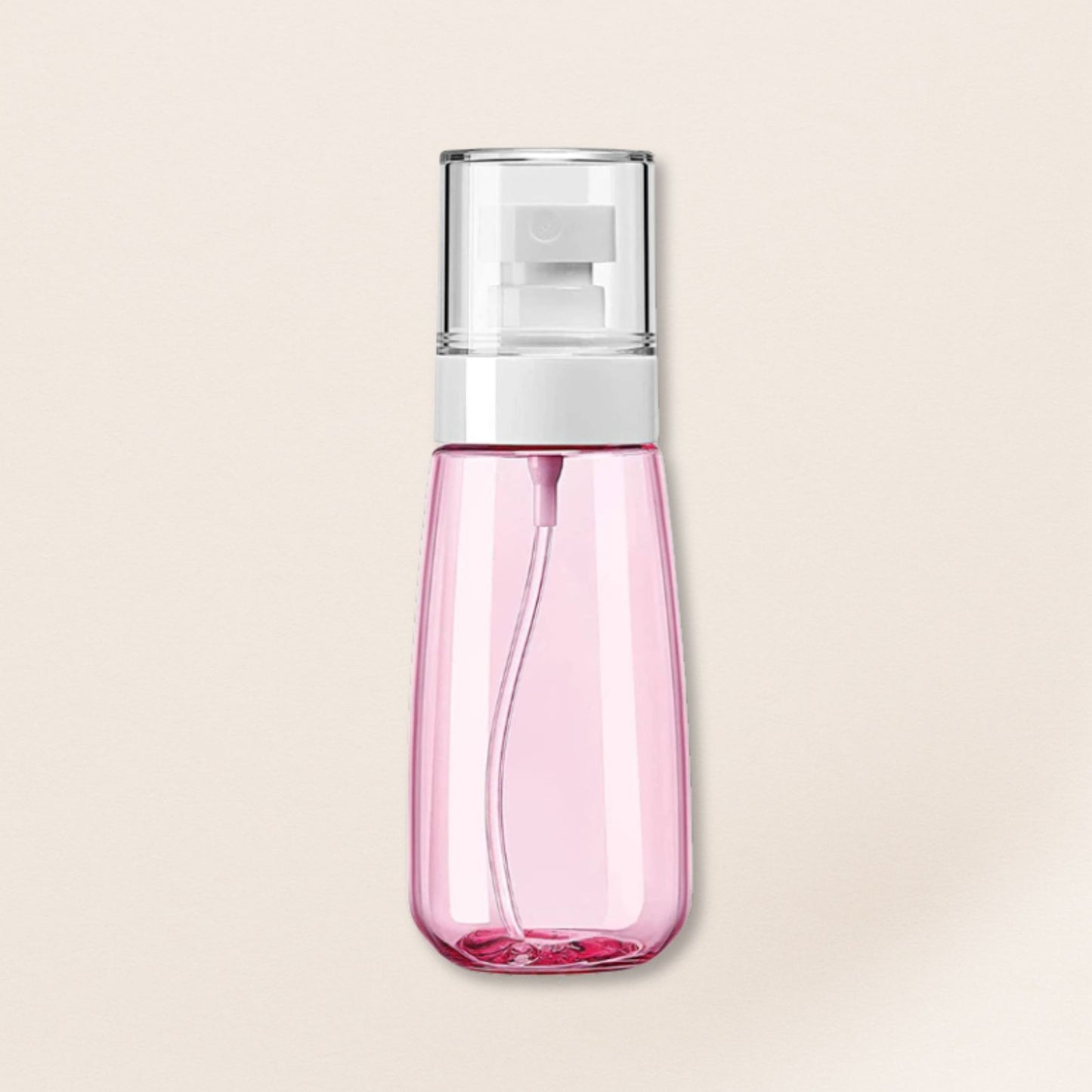 Pink spray bottle with a silver top on a beige background