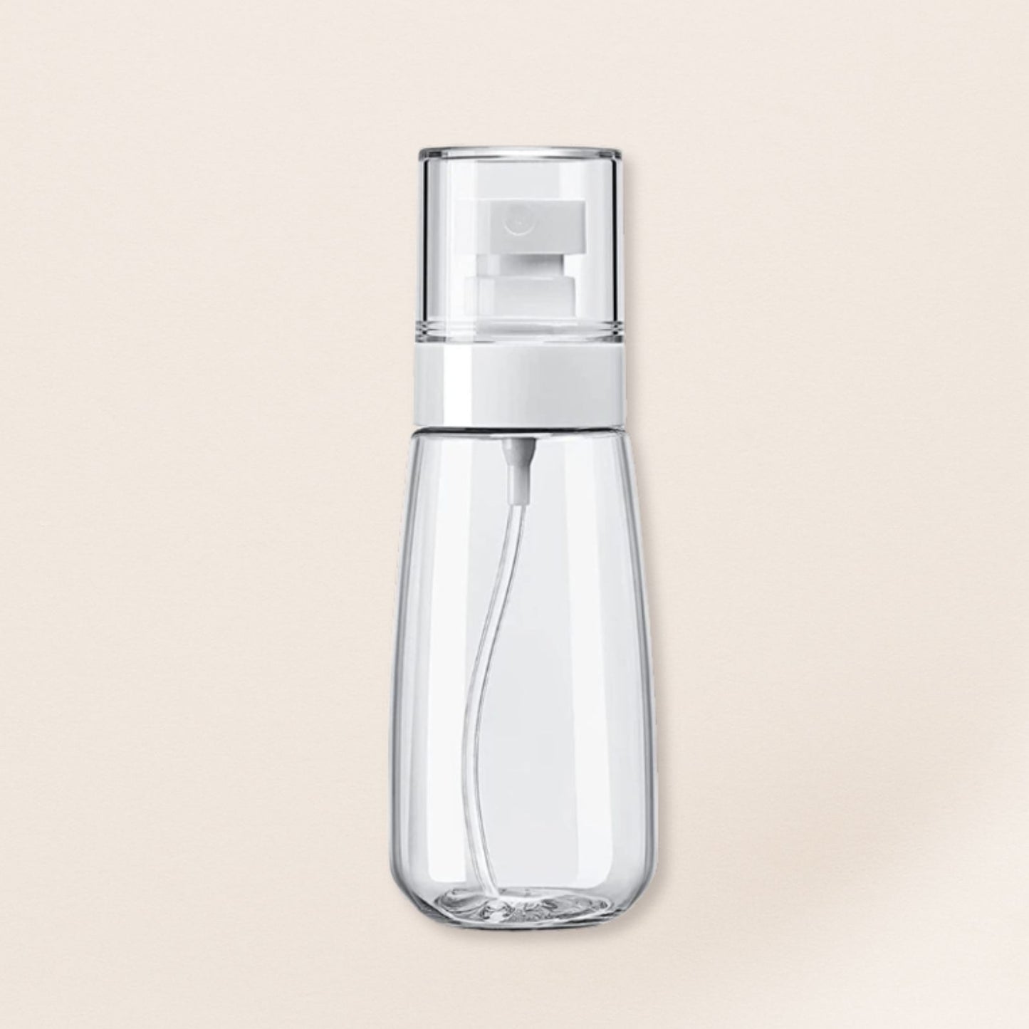 Clear spray bottle with white nozzle on a beige background