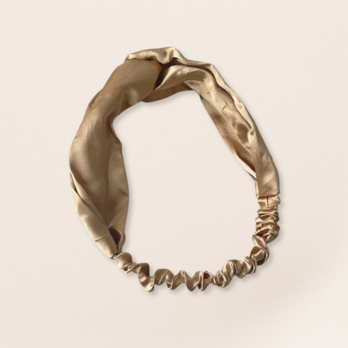 Silver headband on a beige background