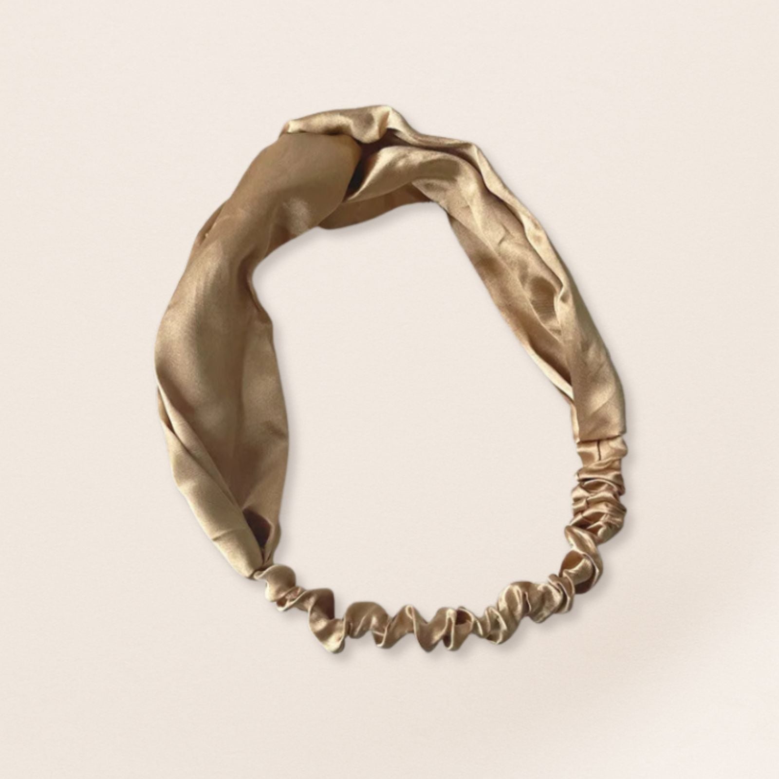 Silver headband on a beige background