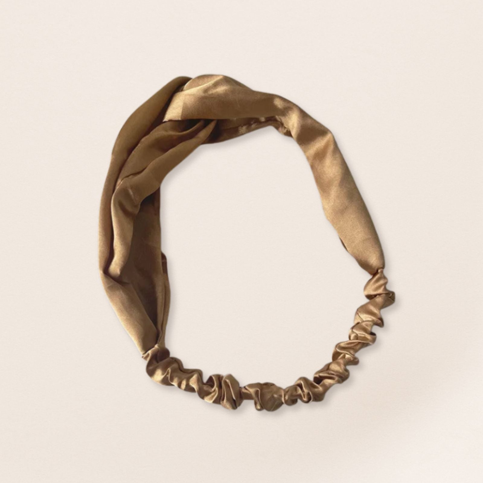 Gold headband on a beige background