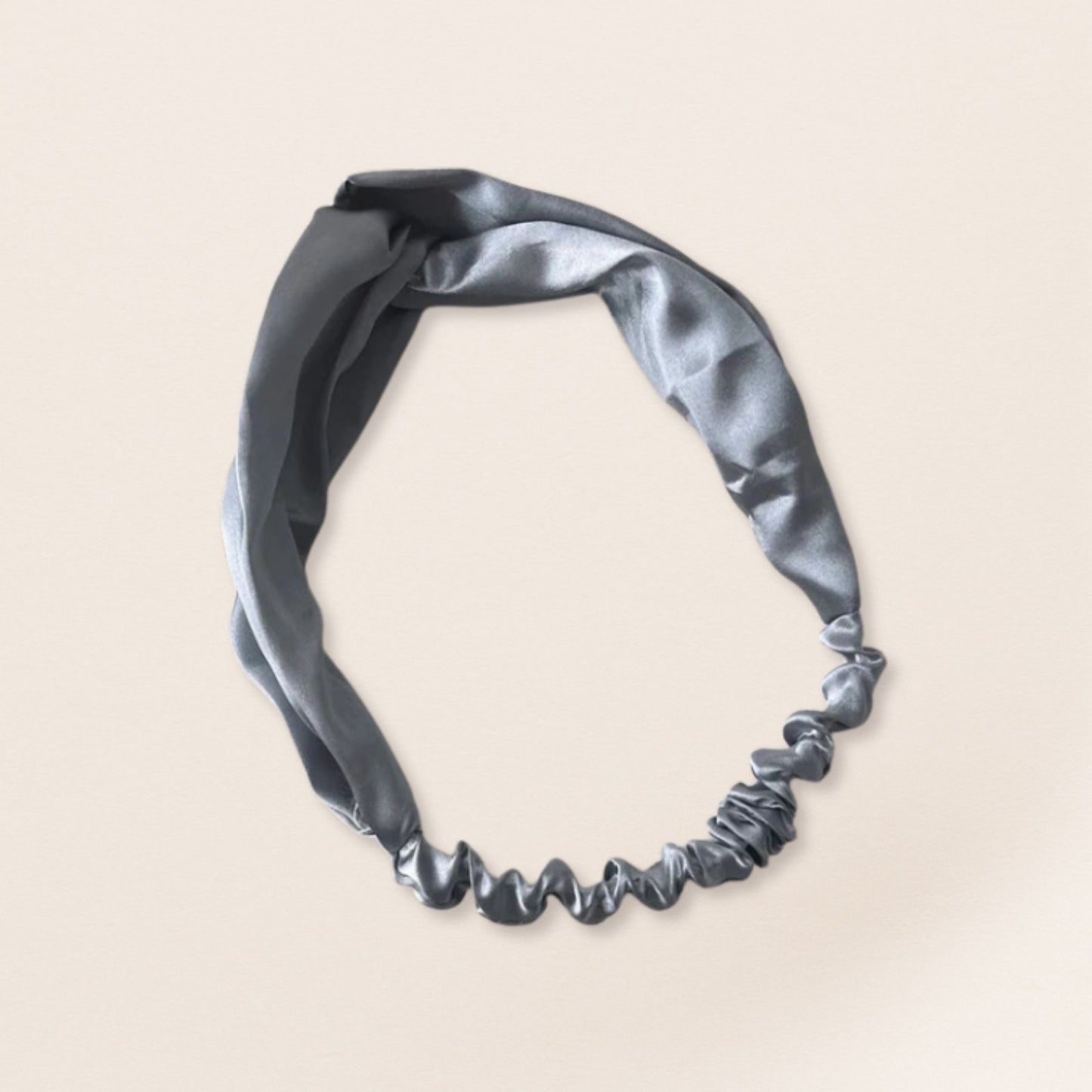 Silver headband on a beige background