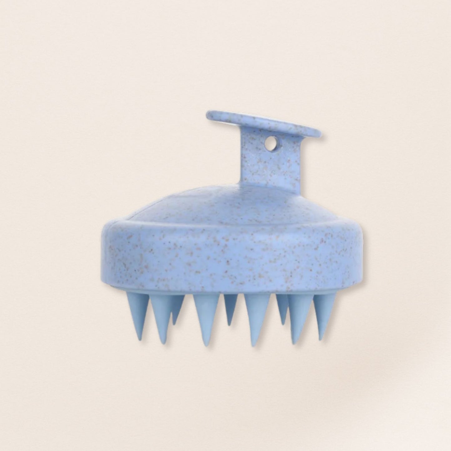 Blue scalp massager on a beige background