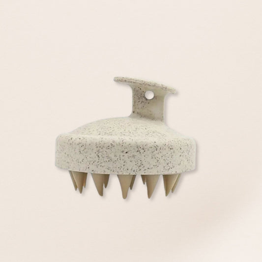 beige scalp massager on a beige background