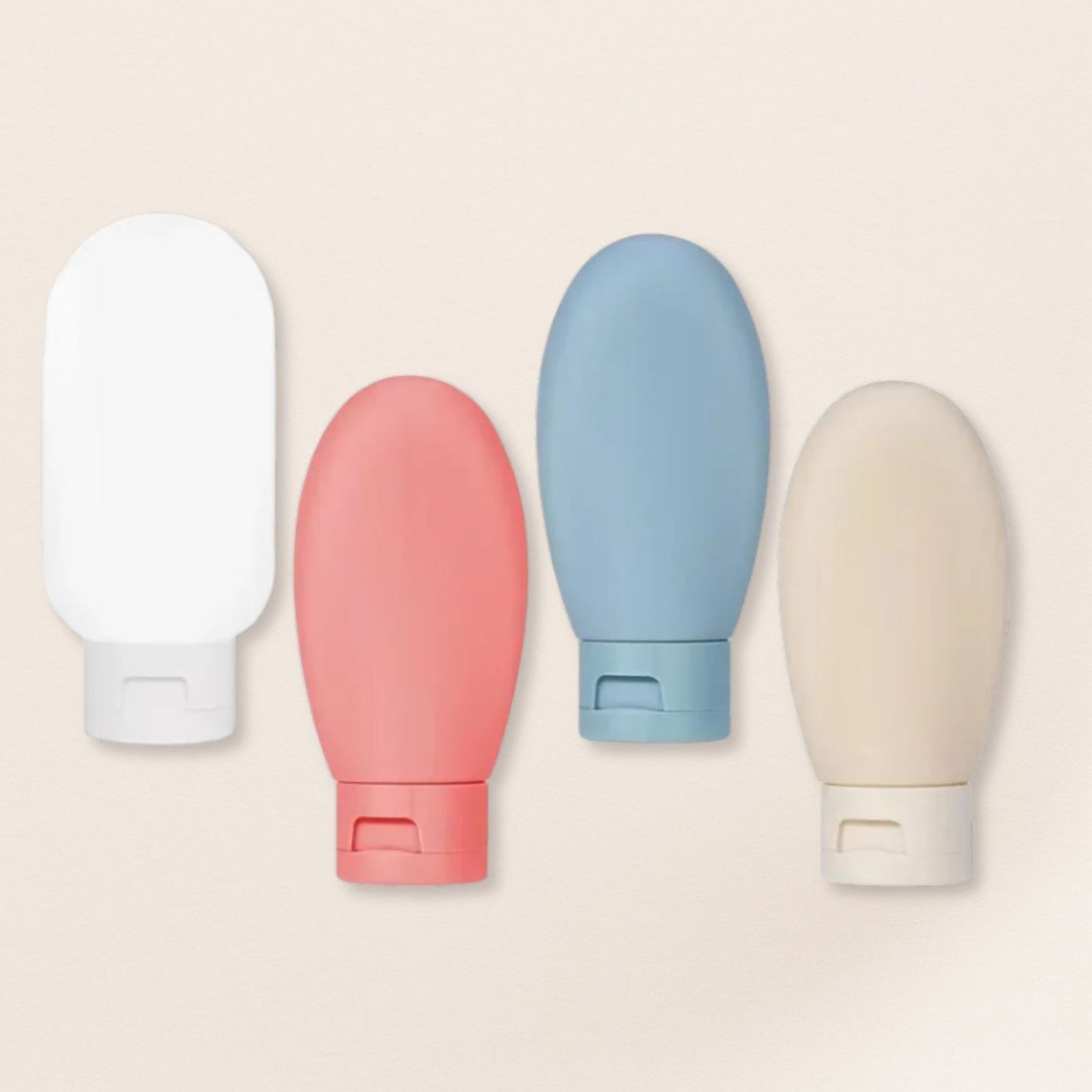 Four colourful bottles on a beige background